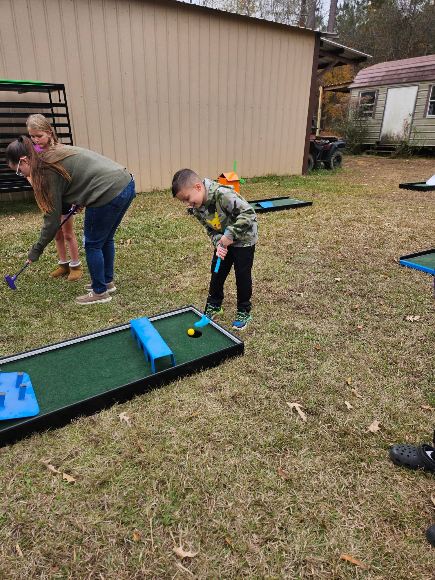 Guests putting on the Putt Zone Texas nine-hole portable course set up outdoors
