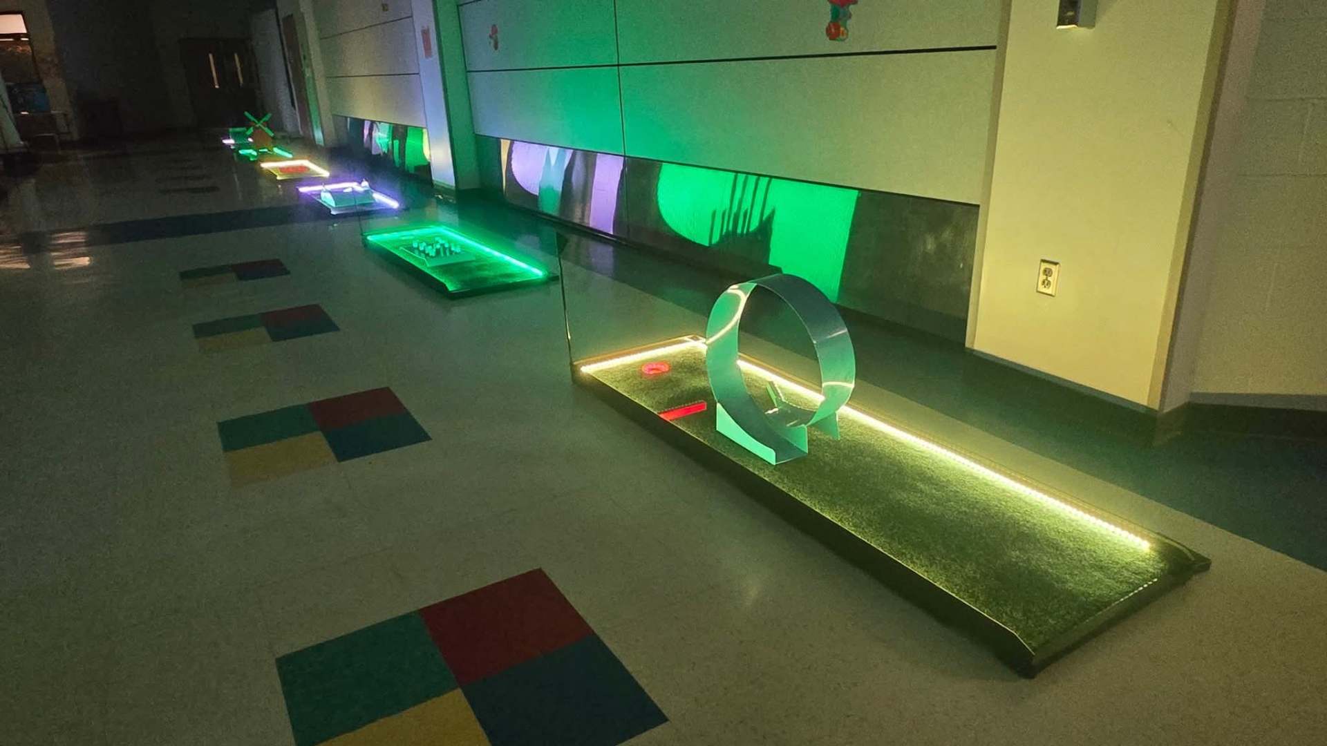 Putt Zone Texas mini-golf hole with a full loop obstacle and yellow LED lighting