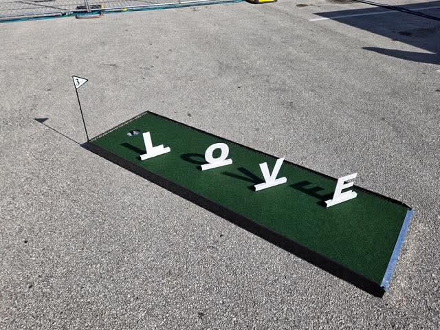 Putt Zone Texas mini-golf lane with LOVE letter decor set up for an event