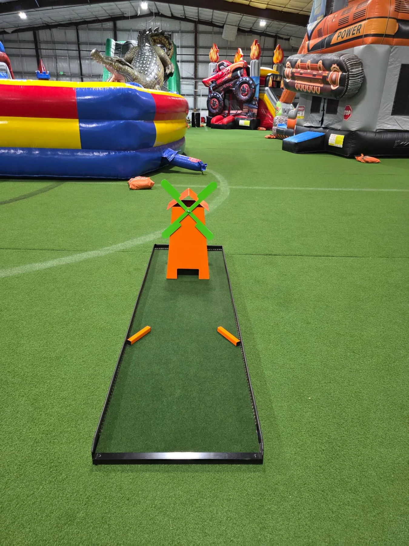 Full Putt Zone Texas mini-golf lane with an orange windmill and green blades
