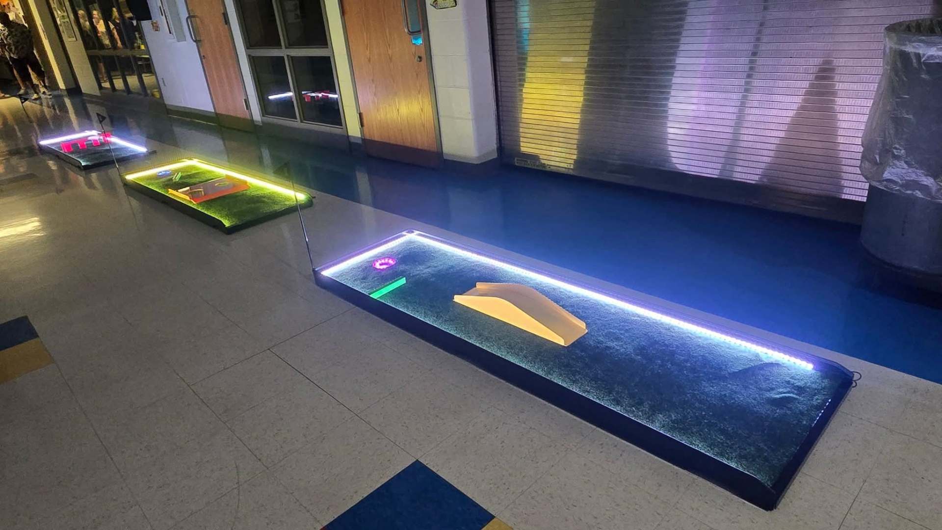 Putt Zone Texas mini-golf lane with a ramp obstacle and purple LED lighting